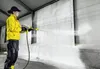 A person is cleaning a wall with a high-pressure washer. Náhled obrázku produktu