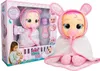 A Cry Babies doll in its packaging, with accessories and a girl holding a doll. Anteprima dell’immagine prodotto