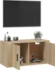 A TV cabinet with a TV mounted above it, and decorative items on top of the cabinet. Voir les images du produit
