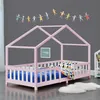 A child's bed with a house-shaped frame, decorated with a garland of paper figures. Náhled obrázku produktu