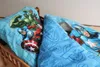 Close-up of Avengers-themed bedding on a wooden bed frame. Produktbild-Vorschau