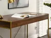 A close-up shot of a wooden desk with a gold frame, featuring an open book and a smartphone on its surface. The background includes white blinds and a wall outlet. Voir les images du produit