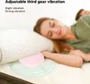 A woman is sleeping on a bed with a pink vibrating device under her pillow. Podgląd zdjęcia produktu