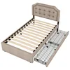 A twin-sized bed frame with a headboard and two pull-out drawers, shown from a slightly elevated diagonal angle against a white background. Náhled obrázku produktu