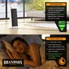 A collage showing a white tower heater and a woman sleeping, with text overlays highlighting features. Podgląd zdjęcia produktu