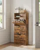 A rustic wooden shoe cabinet with multiple shelves and drawers, placed in a bright room with natural light coming from a window. Produktbild-Vorschau
