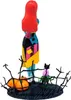 A collectible figure of Sally from The Nightmare Before Christmas, shown from the back, standing on a base with pumpkins and a plant. Podgląd zdjęcia produktu