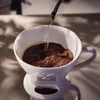 Water is being poured into a coffee filter with coffee grounds. Produktbild-Vorschau