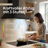 A woman is cooking in a modern kitchen with a black range hood above the stove. Produktbild-Vorschau