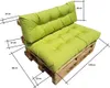 A green cushion set on a wooden pallet base, with dimensions indicated by lines and text. Produktbild-Vorschau