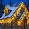 A house decorated with icicle-shaped Christmas lights. Anteprima dell’immagine prodotto