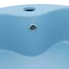 A close-up view of a light blue ceramic sink with a silver drain. Produktbild-Vorschau