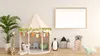 A children's play tent with various stuffed animals and decorative items arranged around it, in front of a blank wall with a framed picture. Produktbild-Vorschau