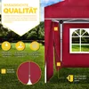 A red pop-up gazebo with a window, set up on a grassy lawn with rain falling. Various feature callouts are present. Produktbild-Vorschau