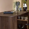 A close-up view of a wooden bar table with decorative items on top and shelves below. Produktbild-Vorschau