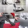 A collage showing a vacuum cleaner head on a floor and a person using a vacuum cleaner attachment on a sofa. Produktbild-Vorschau