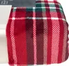 A close-up view of a folded red plaid blanket. Produktbild-Vorschau