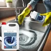 A person wearing yellow gloves is pouring a cleaning product into a kitchen sink. Náhľad obrázku produktu
