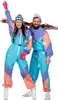 A man and a woman posing in ski suits with skis. Produktbild-Vorschau