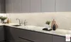 A modern kitchen counter with a sink, cabinets, and backsplash. Anteprima dell’immagine prodotto
