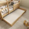 A bunk bed with a pull-out trundle bed is shown in a room with a rug and a wooden toy. Produktbild-Vorschau