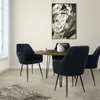 A dining set with four chairs and a round table in a room. Produktbild-Vorschau