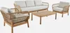 A set of outdoor furniture including a sofa, two armchairs, and a coffee table, all with a natural wood frame and woven rope detailing, and white cushions. Produktbild-Vorschau