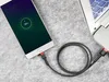 A smartphone is charging from a laptop using a USB cable. Náhled obrázku produktu