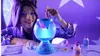 A young woman is making slime with a glowing potion maker. Náhled obrázku produktu