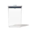 A clear, front-facing studio shot of a clear plastic food storage container with a white and blue lid, set against a plain white background. Produktbild-Vorschau