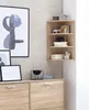 A corner shelf unit with decorative items and a framed picture on the wall. Anteprima dell’immagine prodotto