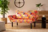 A colorful patchwork sofa in a living room setting. Produktbild-Vorschau