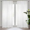 Two white sheer curtains hanging in front of a window. Produktbild-Vorschau