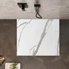 A top-down view of a shower tray with a marble-like pattern, set against a dark tiled floor and a textured ceiling. Náhled obrázku produktu