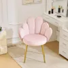 A pink velvet chair with gold legs is placed on a rug in front of a white vanity table. Náhľad obrázku produktu