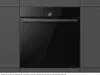 A built-in oven is shown in a modern kitchen setting, integrated into dark gray cabinetry. Voir les images du produit