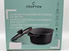 The image shows the packaging of a Crofton aluminum pot with a lid. The packaging features product details in multiple languages and various icons indicating product features. Produktbild-Vorschau