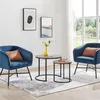 A living room scene with two blue accent chairs, two round nesting coffee tables, and a rug. Produktbild-Vorschau