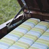 Close-up of the interior of a storage box, showing cushions and a gas strut mechanism. Produktbild-Vorschau