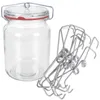 A glass jar with a wire bail lid and a red rubber seal, next to a pile of metal spring clips. Podgląd zdjęcia produktu