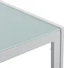A close-up view of the corner of a white table with a light blue glass top. Voir les images du produit