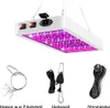 A white LED grow light with purple and red LEDs is shown suspended, with accessories including a wire hanger, a rope hoist, and a power cord laid out below. Produktbild-Vorschau