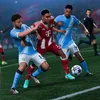 Three soccer players in action on a soccer field during a match. Produktbild-Vorschau