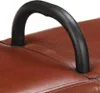 A close-up of a black handle on a brown leather surface. Voir les images du produit