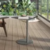A modern balcony setting with lush greenery, a table, and a chair. Anteprima dell’immagine prodotto