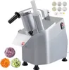 A commercial vegetable slicer with various cutting discs and prepared vegetables. Podgląd zdjęcia produktu