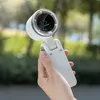 A hand holding a white portable fan with a digital display showing battery life and fan speed. Náhľad obrázku produktu