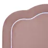 A close-up view of the scalloped edge of a pink upholstered headboard with white piping. Produktbild-Vorschau