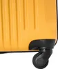 A close-up view of the bottom corner of a yellow suitcase, showing one of its black wheels. Produktbild-Vorschau