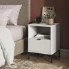 A bedside table next to a bed. Voir les images du produit
